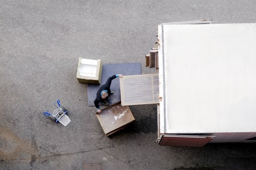 Professional moving team loading furniture for Belsizepark relocation